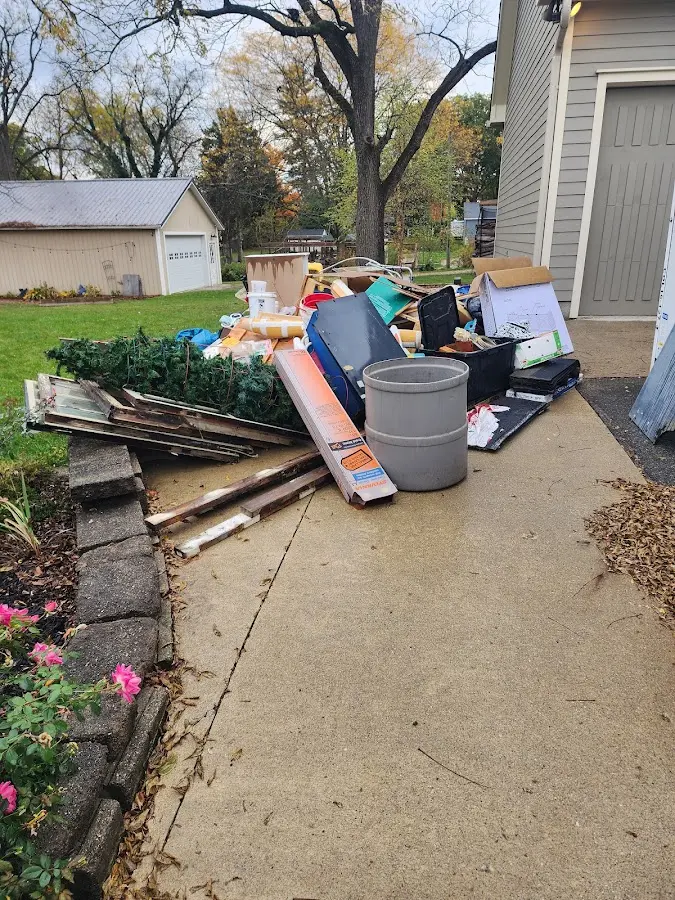 Dumpster being loaded with debris for Roofing Dumpster Rental in Clifton Heights